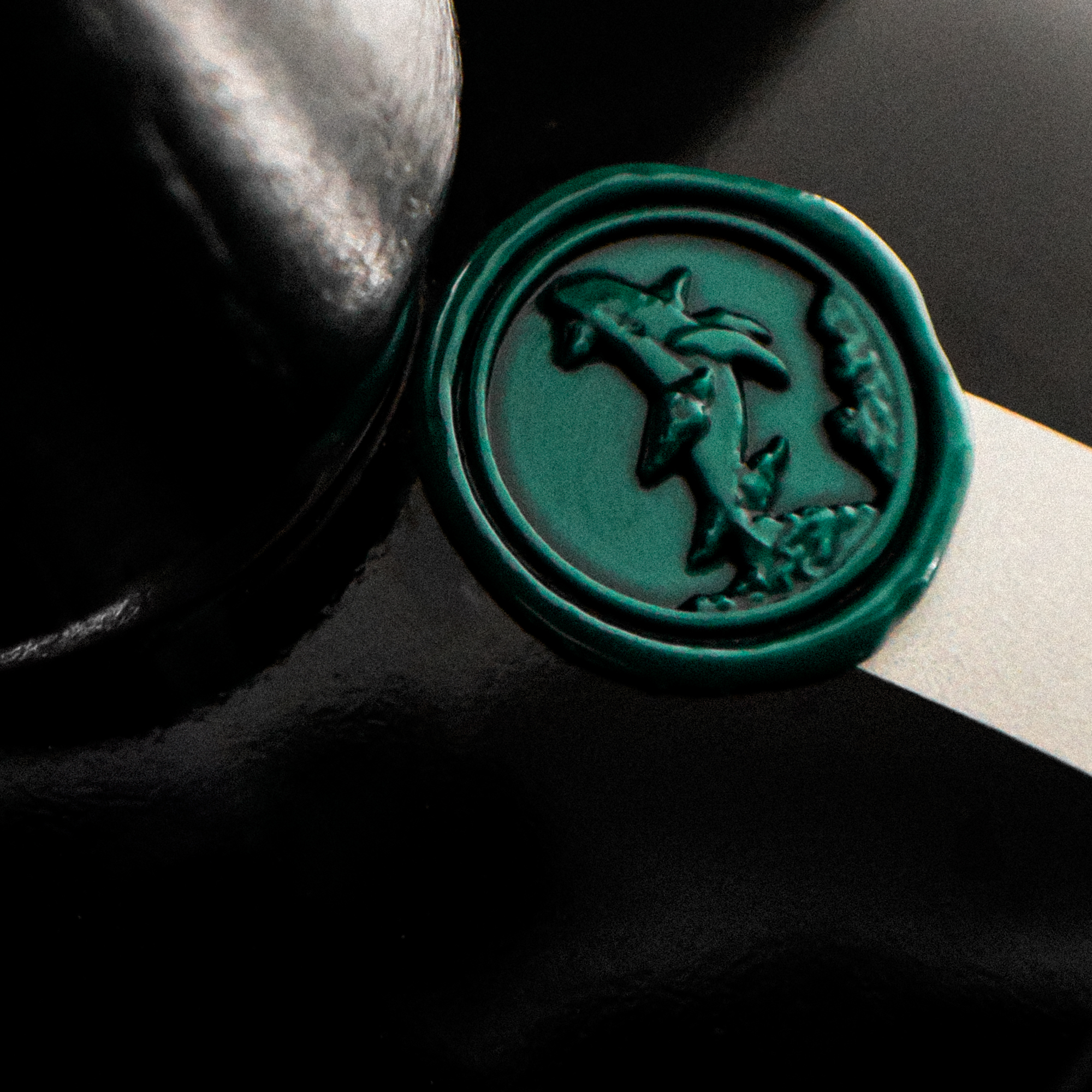VOYAGER clear-glass perfume bottle with an ink-like black appearance and flying whale emblem